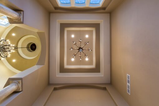 Kingfogl custom home stepped tray ceiling with chandelier and skylights