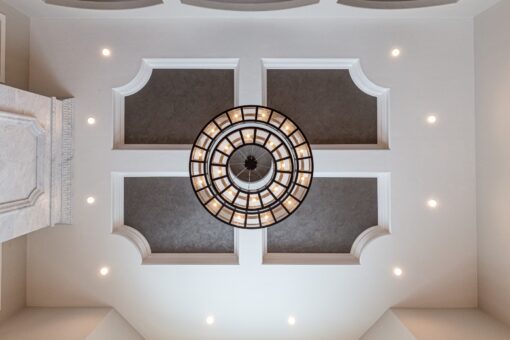 Birchwood coffered ceiling with round chandelier