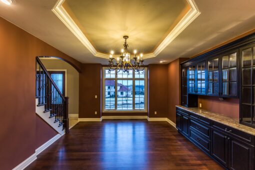 Kingfogl custom home dining room with lit tray ceiling and dark built-in cabinetry