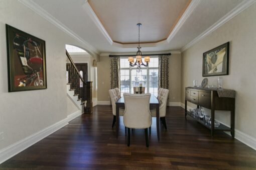 Kingfogl custom home dining room with tray ceiling and view to the staircase
