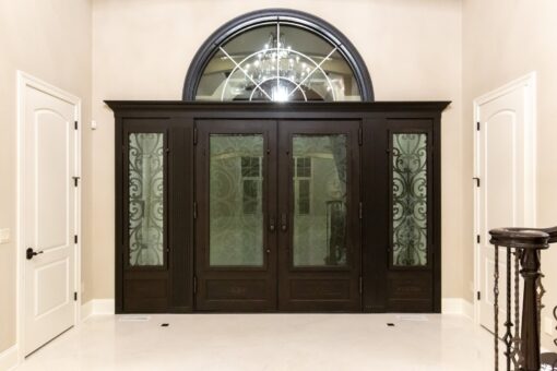 Vizzini iron and glass double entry doors with arched transom