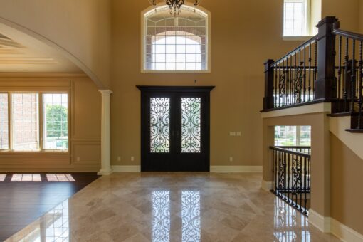 Rivendell foyer with iron and glass entry doors and arched window