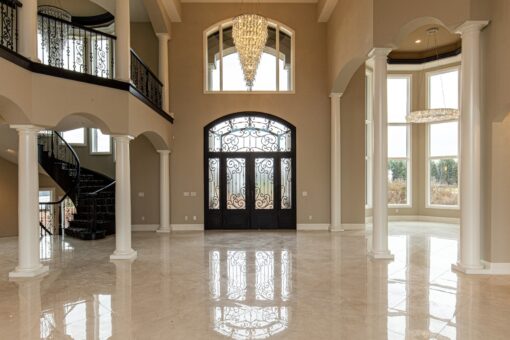 Saddlebrook foyer with iron double entry doors and curved staircase