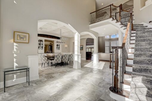 Wildwood foyer with curved staircase and columns