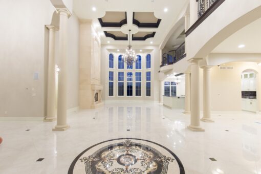 Kingfogl custom home two-story foyer with marble medallion and columns