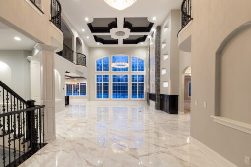 Kingfogl custom home foyer with iron staircase and coffered ceiling