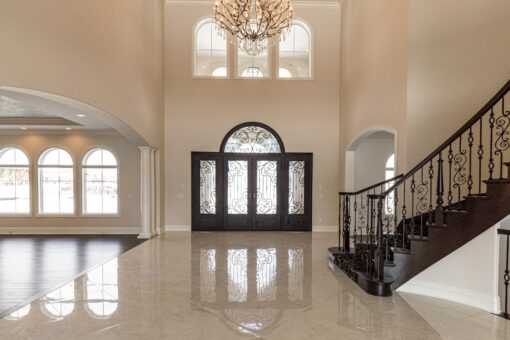 Prescott two-story foyer with arched windows, staircase and chandelier