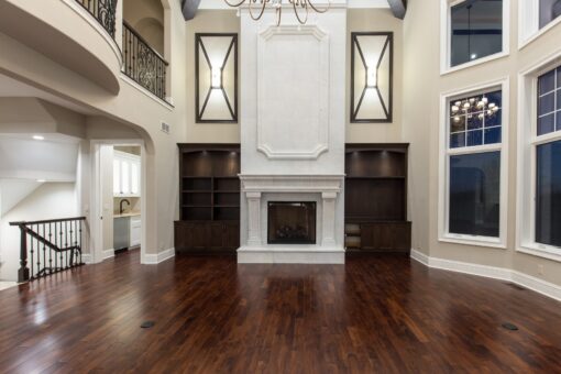 Bella Haven great room fireplace with built-ins and decorative mirrors
