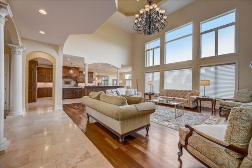 Kingfogl custom home two-story great room with window wall, columns and chandelier