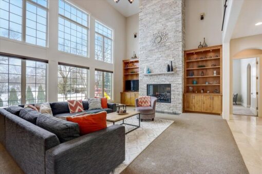 Ridgeview two-story great room with stone fireplace and built-ins