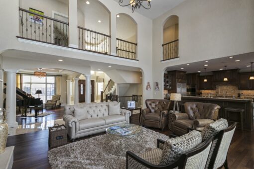 Kingfogl custom home great room with iron balconies and arched openings