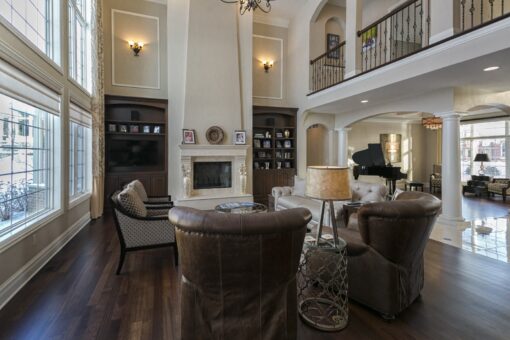 Kingfogl custom home great room with fireplace built-ins and balcony above