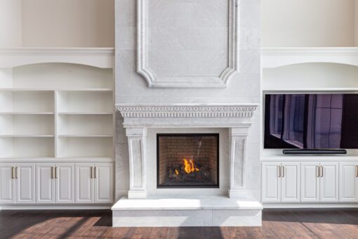 Prescott great room fireplace flanked by built-in cabinetry