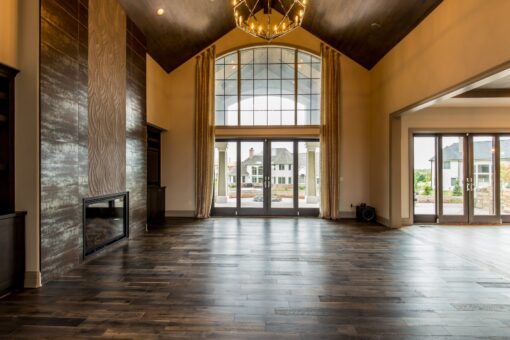 Compton great room with arched window wall and stone fireplace