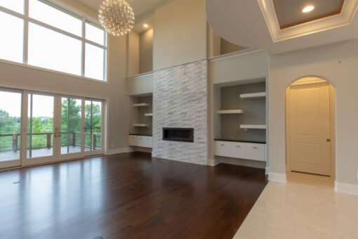 Ravenna great room with stacked stone fireplace wall and built-in shelves