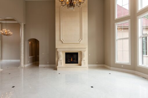 Kingfogl custom home great room with cast stone fireplace and marble floor