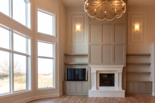 Sanctuary great room fireplace with paneled wall and built-ins