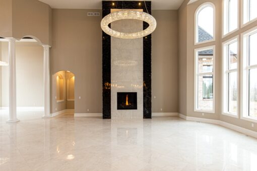 Kingfogl custom home great room with black stone fireplace and ring chandelier