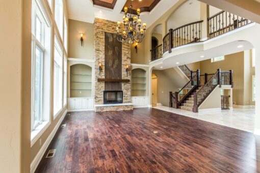 Kingfogl custom home great room with stacked stone fireplace and open staircase