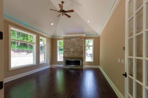 Kingfogl custom home hearth room with stacked stone fireplace and vaulted ceiling