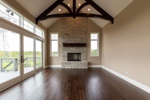 Grand Haven hearth room with stone fireplace and timber beams