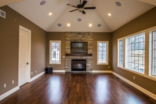 Kingfogl custom home hearth room with stone fireplace and vaulted ceiling
