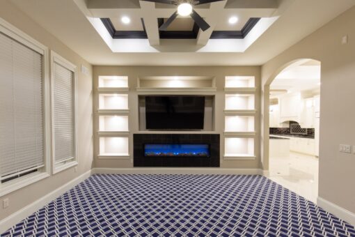 Vizzini hearth room with linear fireplace and lit built-ins
