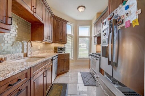 Edington kitchen with wood cabinetry and stainless appliances