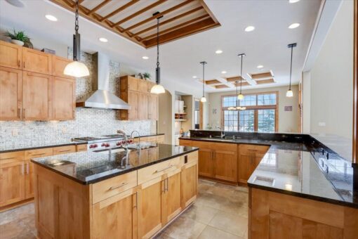 Ridgeview kitchen with maple cabinetry and black granite