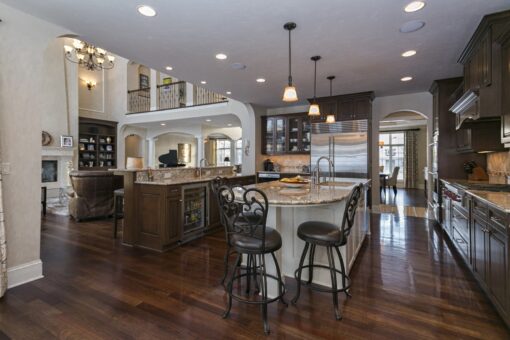 Kingfogl custom home kitchen with granite island, bar seating and view to the balcony