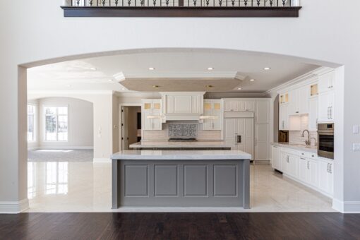 Prescott white kitchen with gray island and pendant lights