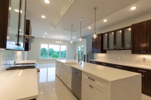 Ravenna white kitchen with dark upper cabinetry and island