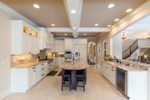 Summerhill white kitchen with dark island and coffered ceiling