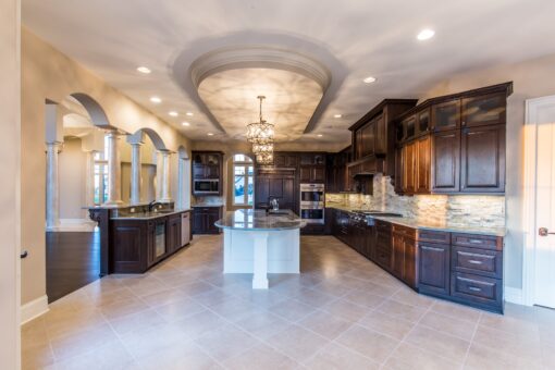 Presidio kitchen with curved island and dark wood cabinetry