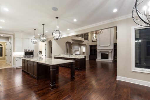 Kingfogl custom home white kitchen with two islands and globe pendants