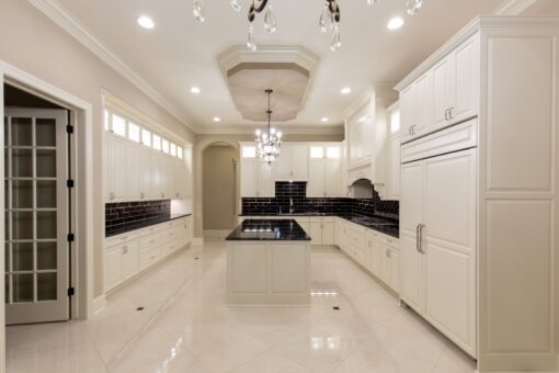 Vizzini white kitchen with island and tray ceiling