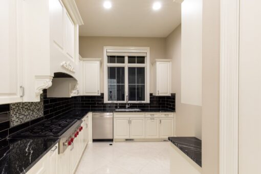 Kingfogl custom home white kitchen with black granite counters and subway tile