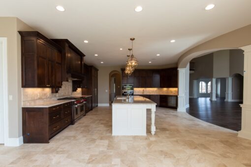 Grand Haven kitchen with dark wood cabinetry and pendant lights