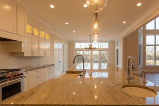 Sanctuary kitchen with glass pendants and lit cabinetry