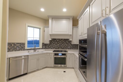 Callista kitchen with white cabinetry and tile backsplash
