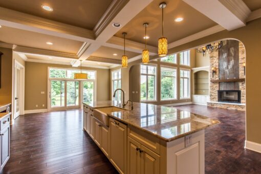 Kingfogl custom home kitchen island with farmhouse sink and view to the hearth room
