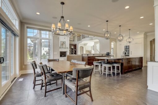 Kingfogl custom home kitchen and dining area with chandelier and view to the island