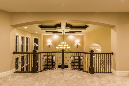 Kingfogl custom home loft with coffered ceiling and iron railing
