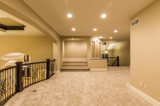 Kingfogl custom home loft with iron railing and steps to an upper landing
