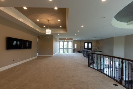 Grand Haven loft with iron railing and tray ceiling