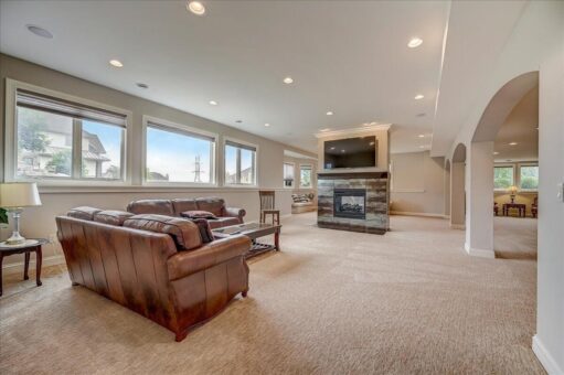 Edington lower-level family room with fireplace and windows