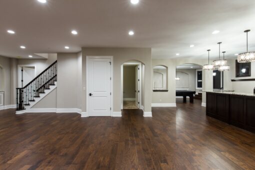 Kingfogl custom home lower-level open space with staircase, bar and game room