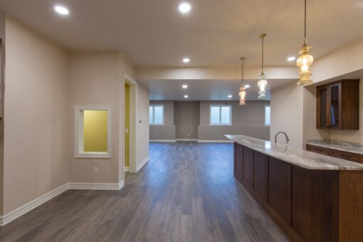 Auburn lower-level bar with wood cabinetry