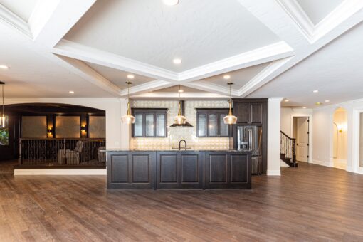 Prescott lower-level bar with dark island and coffered ceiling