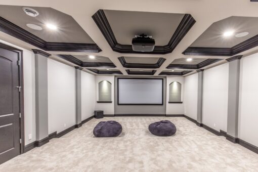 Kingfogl custom home lower-level home theater with coffered ceiling and screen